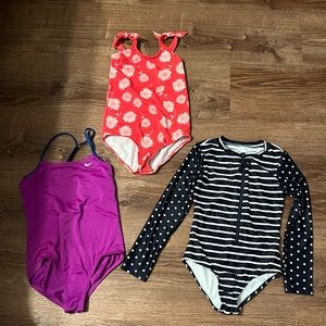 Girls 3 one piece swimsuits. Size M. They are in good condition.